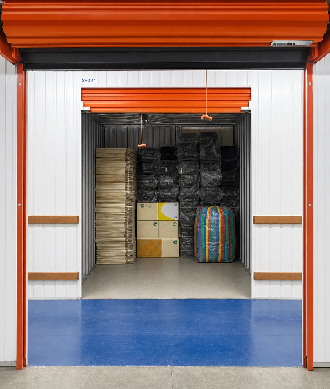 A BSS storage room with boxes and wrapped furniture